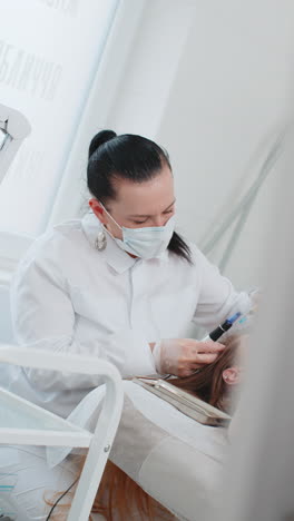 trichologist doing woman hair regeneration procedure, dermapen microneedling, vitamin injections