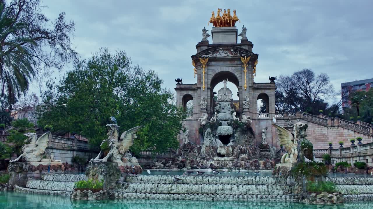 Cascada Monumental fountain in Barcelona's Parc de la Ciutadella features intricate neoclassical design with multiple tiers, triumphal arch motifs, and mythological sculptures