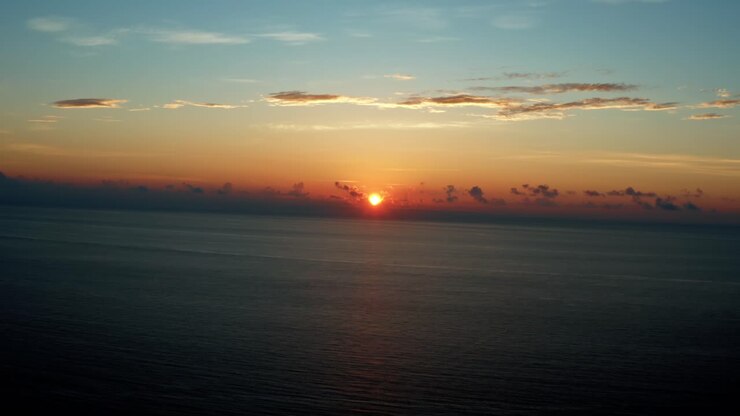 Beautiful right tracking Aerial drone landscape shot of a stunning colorful tropical sunrise in Riviera Maya near Cancun, Mexico on a warm summer morning.