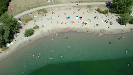 Aerial View of Lake Beach with People Relaxing and Swimming