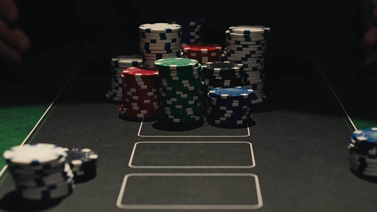 Hands managing poker chips on green table, reflecting intense poker gameplay with the element of chance and skill