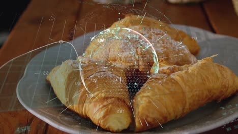 animation of data processing and globe over croissants on wooden table