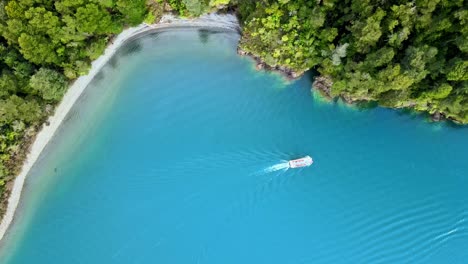 overhead view of a boat near the shore of lake todos los santos in southern chile