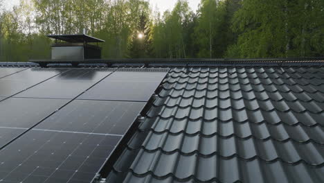 aerial view close to solar panels on a house roof, on a sunny, summer evening