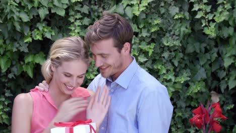 Handsome-man-surprising-his-girlfriend-with-a-present