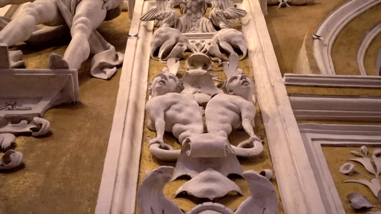 Stuccoes and statues inside the Serpotta Chapel of Castelbuono Castle, Sicily. Angels, devils, and fierce demonic faces decorate this masterpiece, showcasing Baroque artistry at its finest.