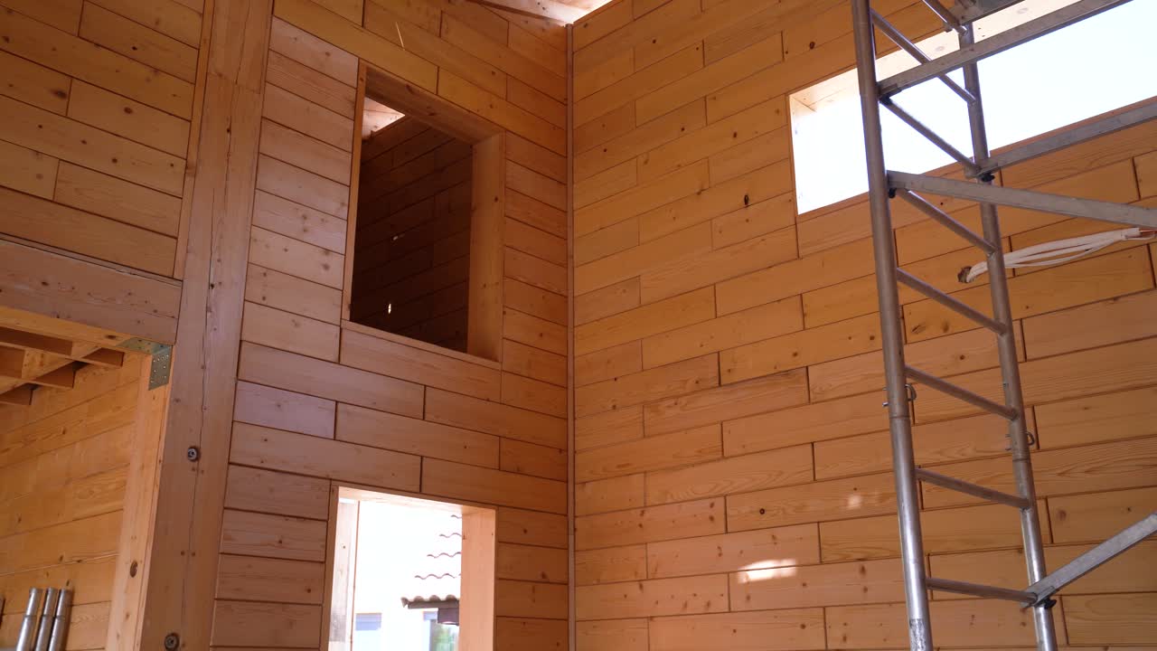 Wooden Interior Under Construction with Exposed Frame and High Ceilings