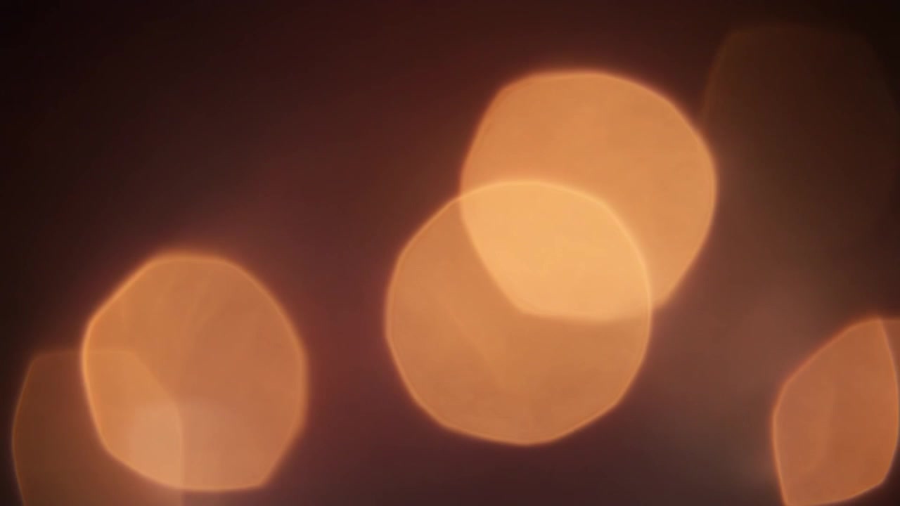 Abstract Golden Bokeh Light Leaks on Dark Background