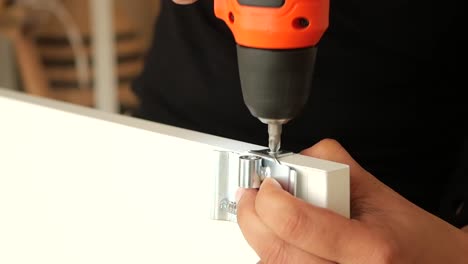 installing cabinet hinges with an electric drill