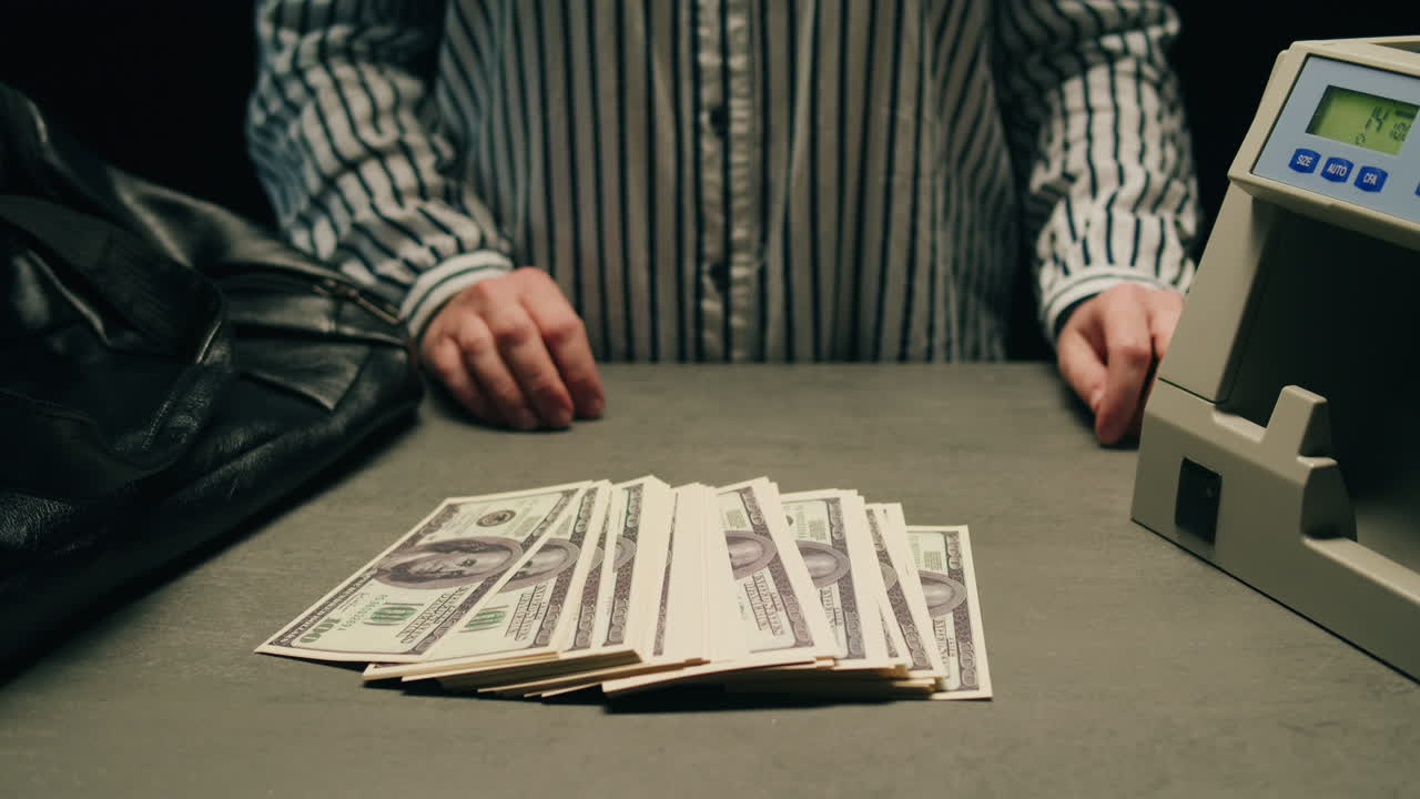 Specialised police officer Counting dollar banknotes in crime lab, conceptual image. High quality 4k footage