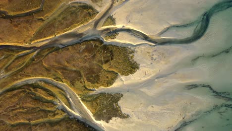 overhead truck left view of the vein-like formations at the mouth of the rio blanco in the pacific ocean at hualaihue, chile