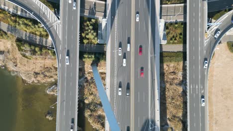 an aerial bird's-eye perspective captures the shandong province linyi bridge over the benghe river in china, with flowing car traffic beneath the daytime sunshine