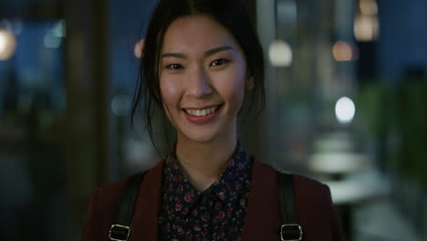 portrait happy young asian business woman student smiling enjoying professional lifestyle beautiful independent female in late urban evening slow motion