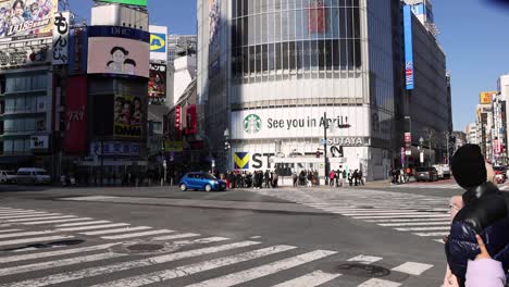 pedestrians crossing a busy urban intersection