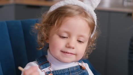 cute child wearing bunny ears engaged in an activity