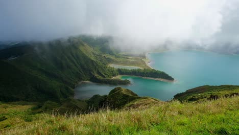 an early morning scene for lagao do fogo crater lake in the azores while it's engulfed in clouds