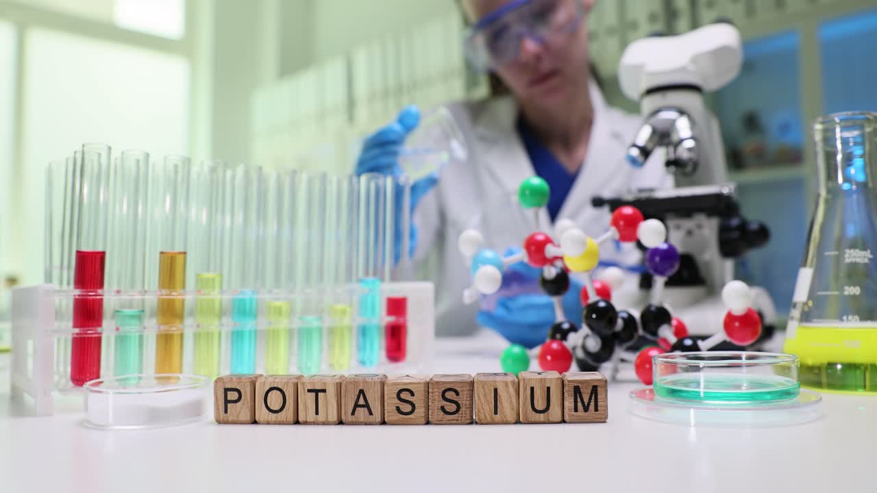 Potassium experiment in a chemistry laboratory with a scientist