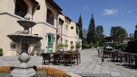 sunny courtyard with fountain and seating area