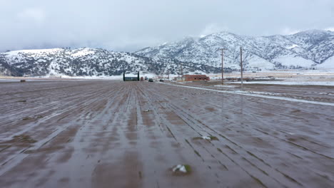 Flying-toward-a-wintery,-snowy-farm-in-Tehachapi,-CA