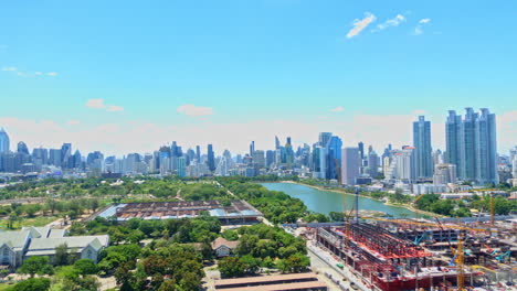 timelapse of bangkok, thailand, sunny day over colorful cityscape, benjakitti park and construction site