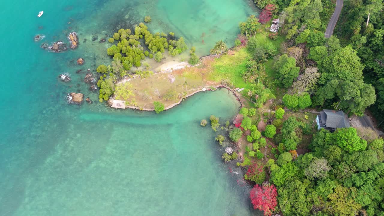 Aerial drone footage capturing the tranquil Bailan Village, beach, and tropical resorts on Koh Chang, Thailand