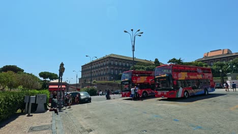 red buses navigate busy naples streets