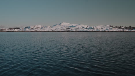 Majestic-views-of-the-Western-Fjords-of-Norway,-featuring-snowy-mountains-and-serene-water