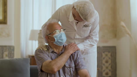 female therapist holding patient by shoulder after vaccination