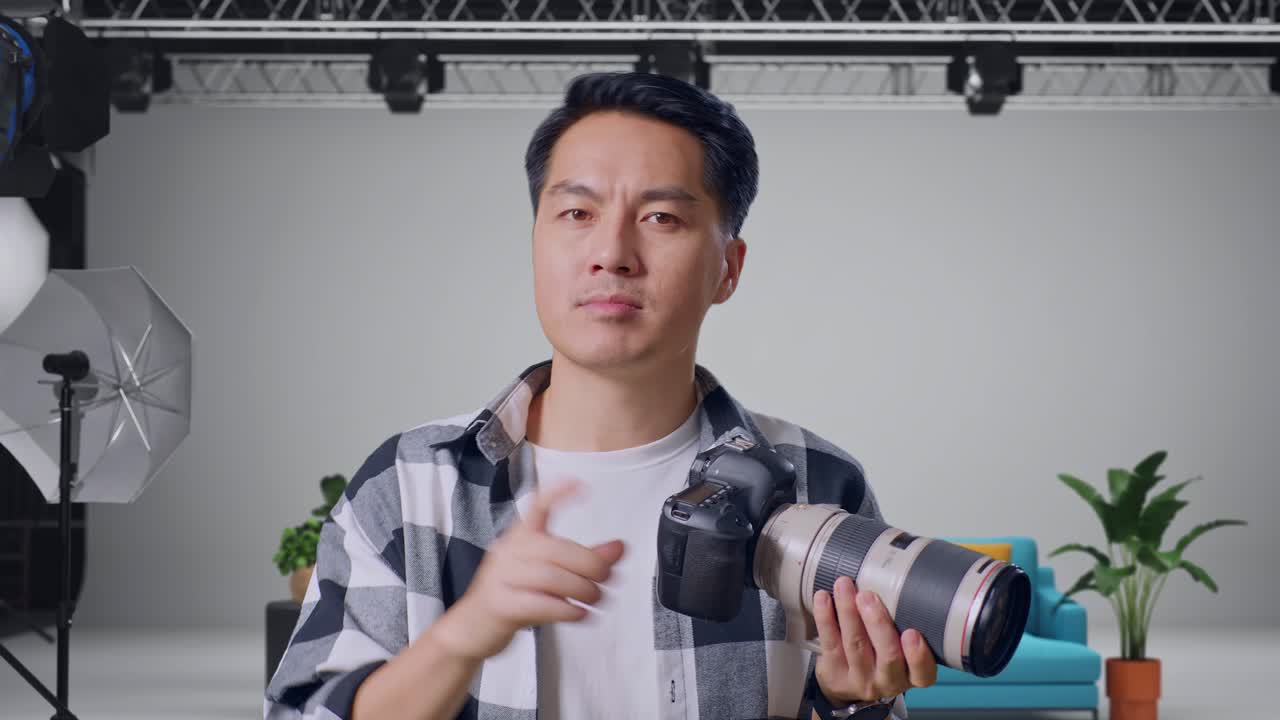 Photographer holding a camera in a studio