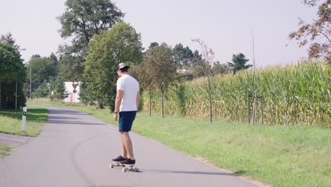 man longboarding in the countryside