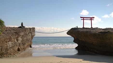 beautiful scenery at famous shirahama beach in japan with rocks and traditional torii gate