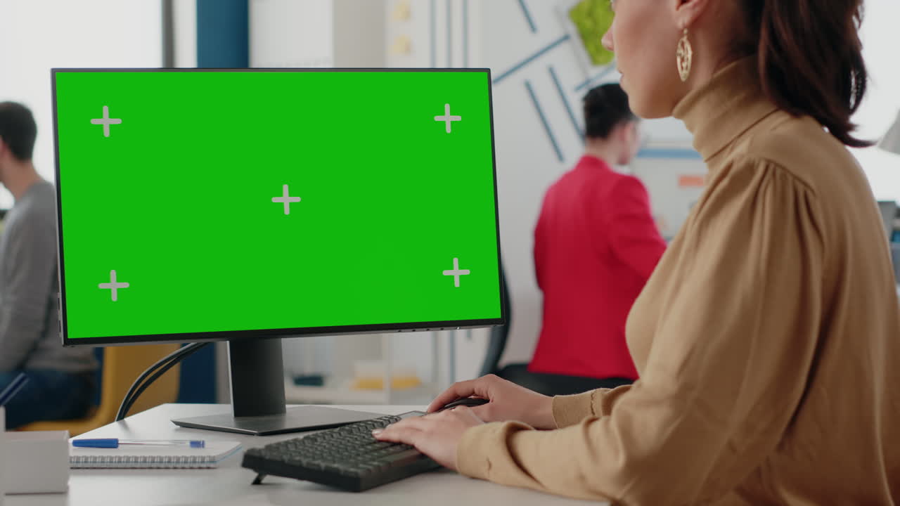Close up of woman using computer with isolated green screen