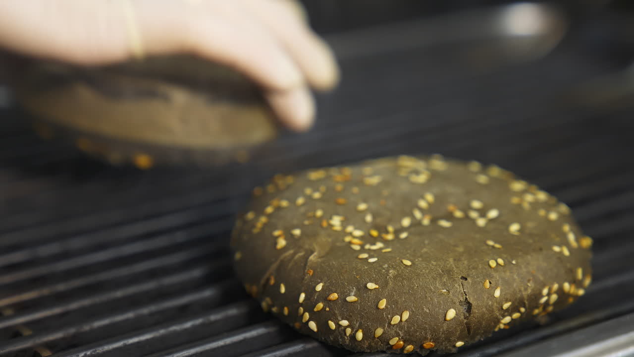 Cooking burger in the kitchen. Professional chef preparing burger at restaurant kitchen