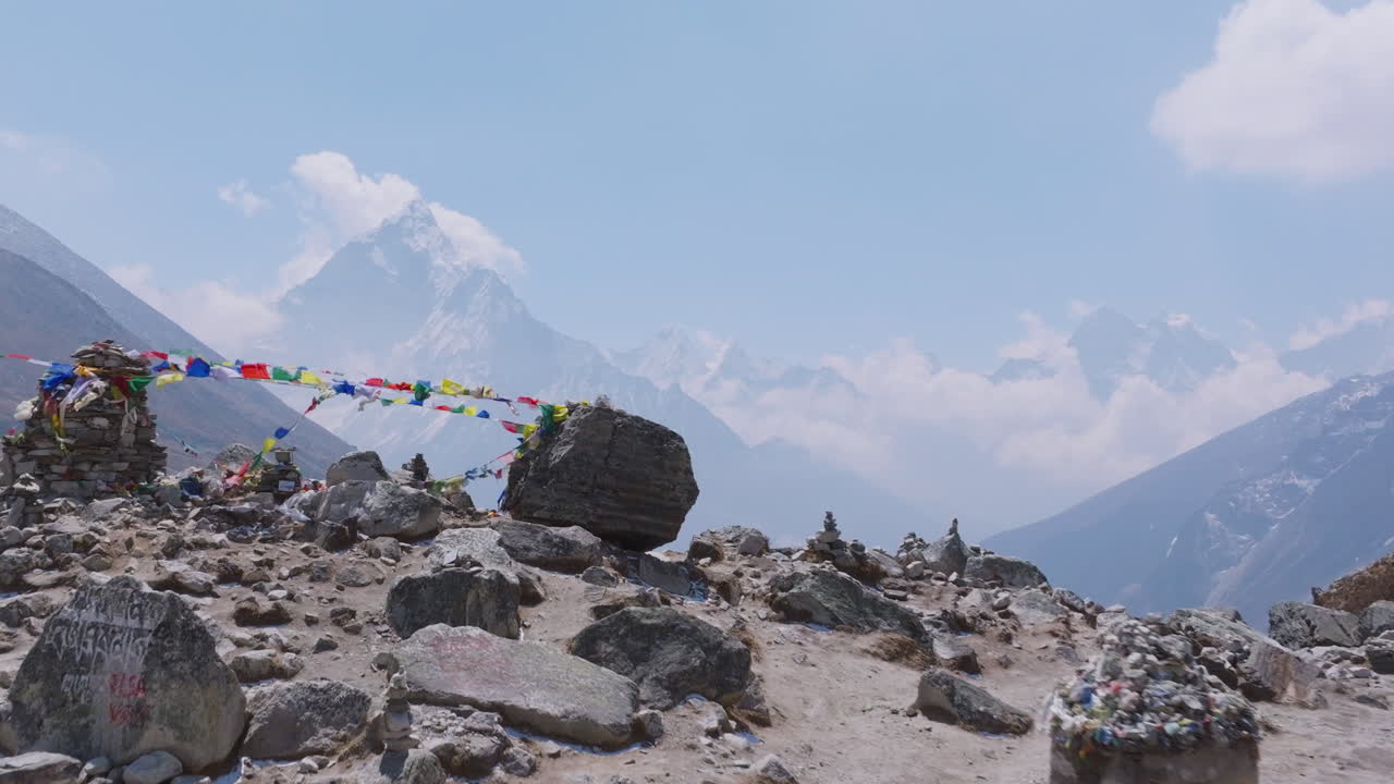 Mountain landscape with prayer flags and stone stacks