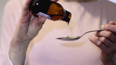 healthcare pouring cough medicine in a teaspoon stock video stock footage