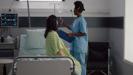 medical nurse black woman checking hospitalized sick patient