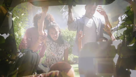 animation of happy african american family unpacking car over leaves