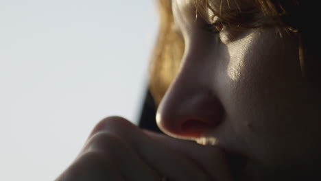 Close-up-girl-looking-out-car-window-thinking-with-sad-expression