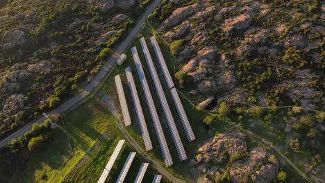 antena de arriba hacia abajo de la estación de energía solar fotovoltaica, la inclinación revela una turbina eólica por mar