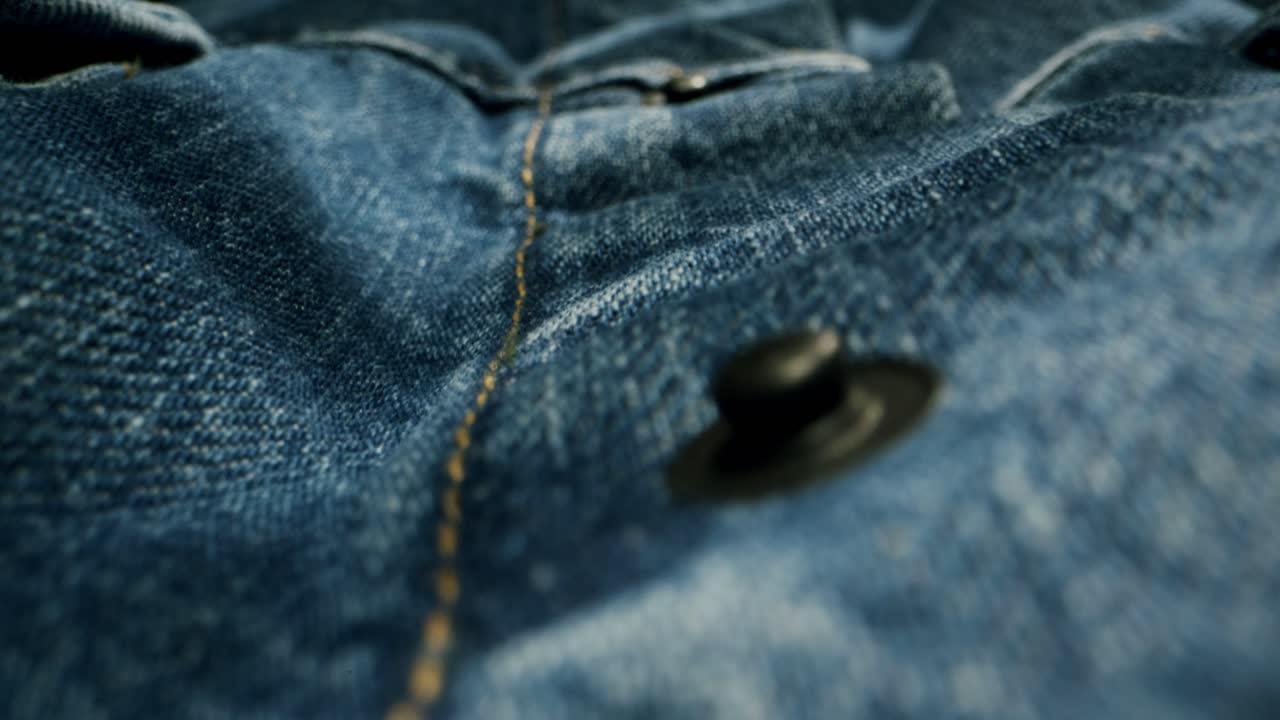 Blue textile jeans cloth texture close-up macro. Fashion fabric multicolor. Cotton casual clothes