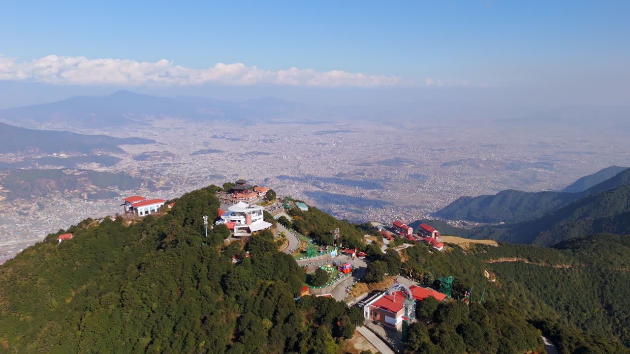 Establishing aerial view of the Chandragiri hill and Kathmandu city, sunny Nepal