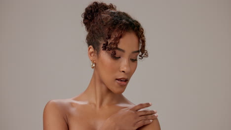 beautiful young woman with curly hair and a smile posing for a portrait.