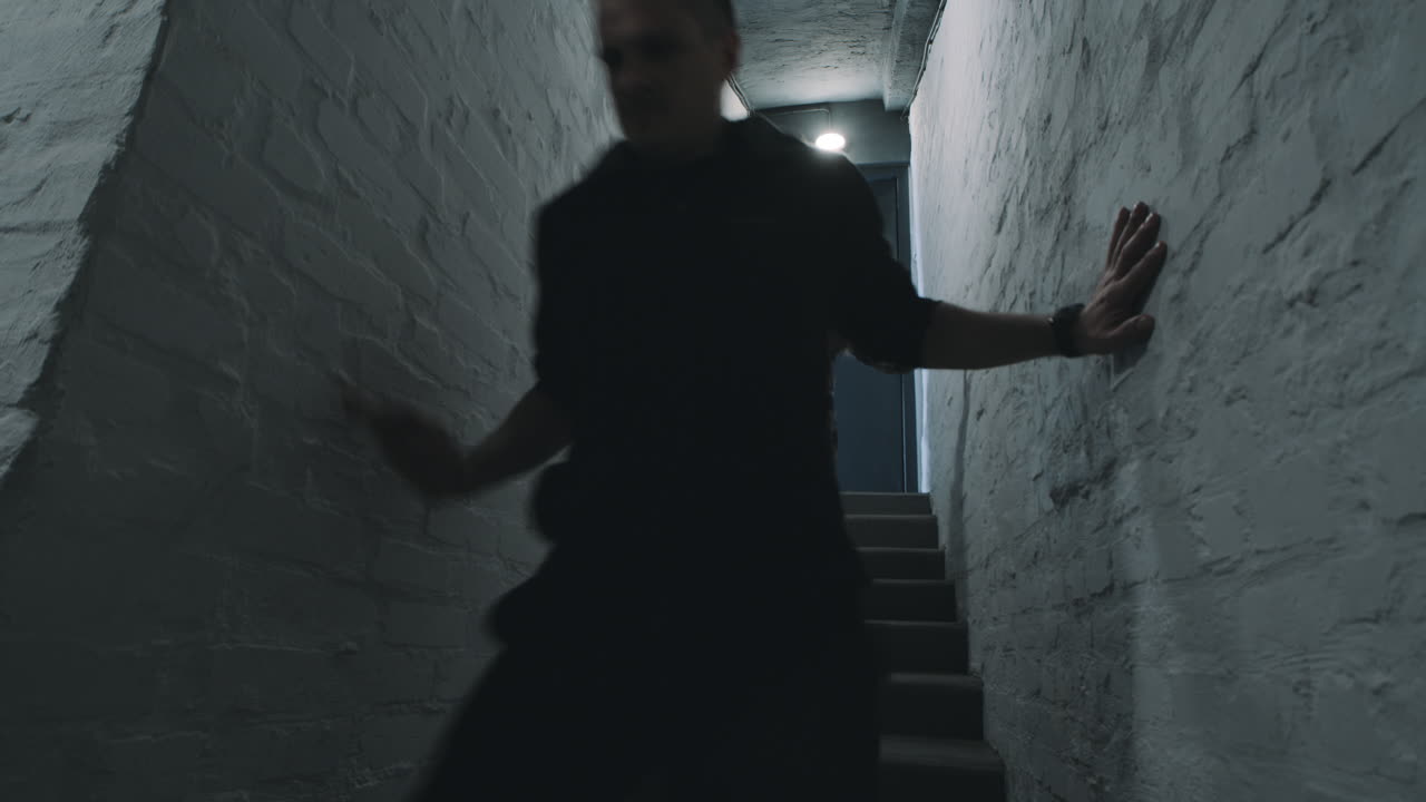 People Walking Down Stairs in Basement