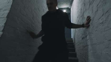 people walking down stairs in basement