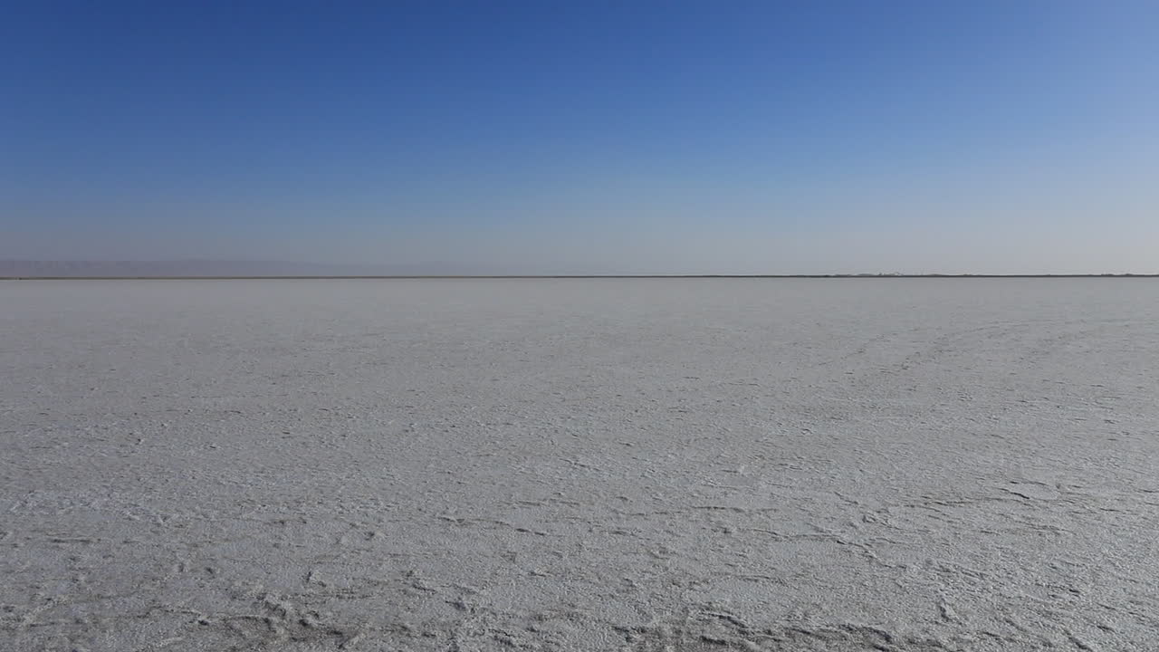 Vast salt flats of Chott el Jerid under clear blue skies, Tunis, wide shot