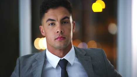 a young businessman standing in an office at night