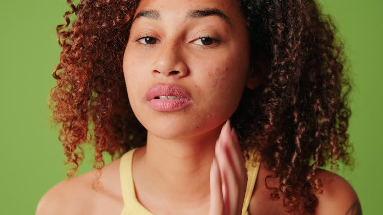 Young Woman Checking Her Skin and Smiling on Green Screen