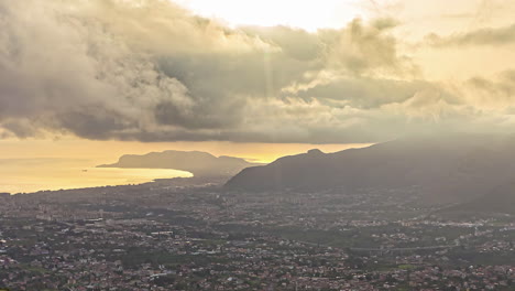 high angle shot over the city of sicily, italy on a cloudy evening in timelapse