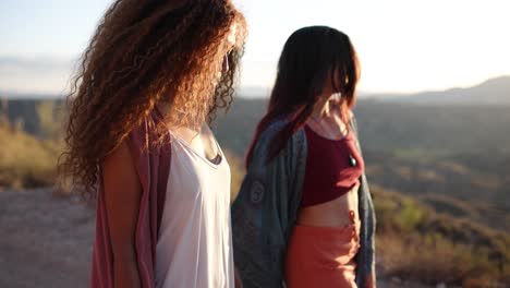 two women friends walking outdoors during golden hour