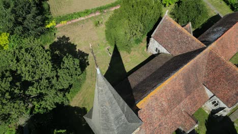 a top-down arc shot of st john the evangelist church's steeple and spire